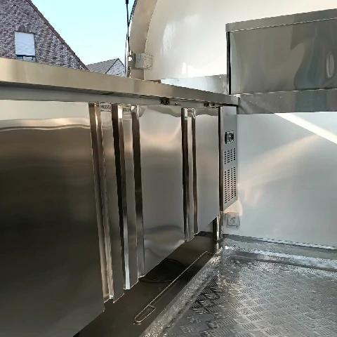 Compact rounded food trailer for mobile vending and catering use.