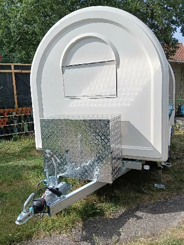 Compact rounded food trailer for mobile vending and catering use. ice cream trailer